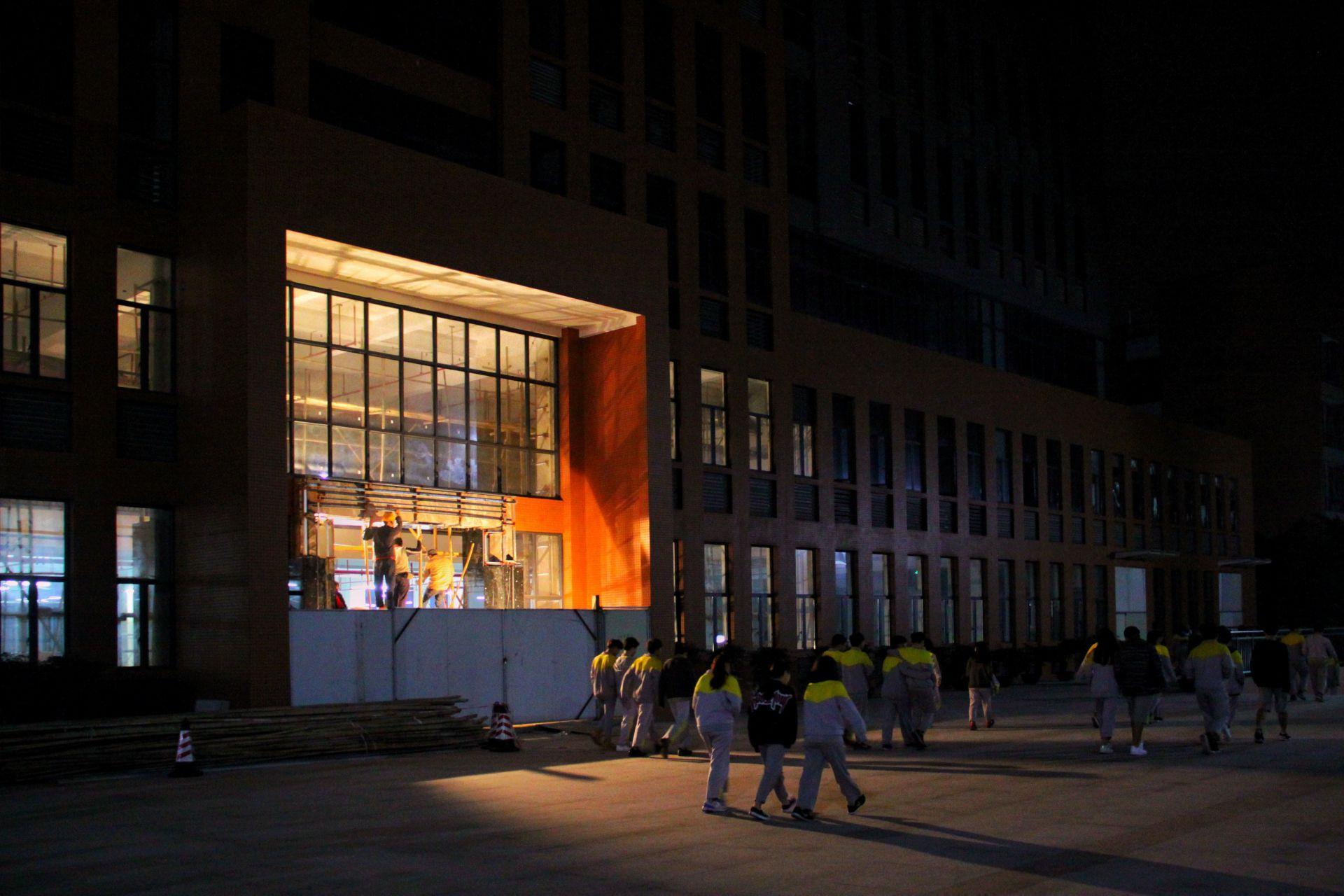 The administrative building that was still under construction at the time; it was completed the following year.